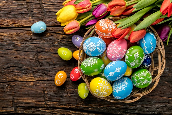 Easter eggs and tulips on a wooden table