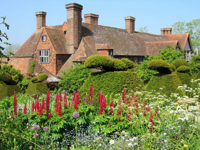 Tudor house with a formal garden and lupins