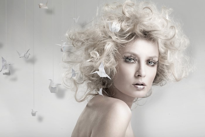 Blonde girl with origami cranes