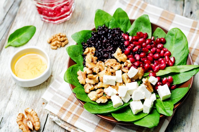 Salad with black rice, pomegranate, walnuts, and feta cheese