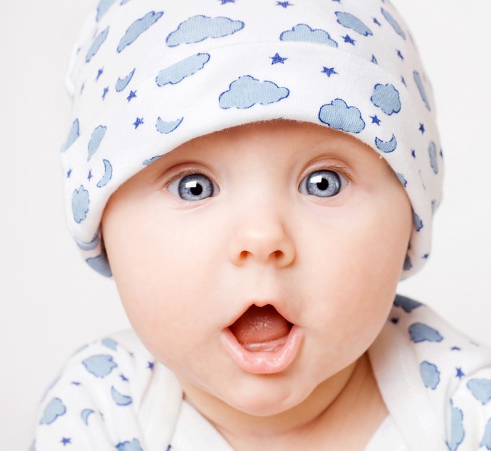 Baby wearing a cloud-patterned hat