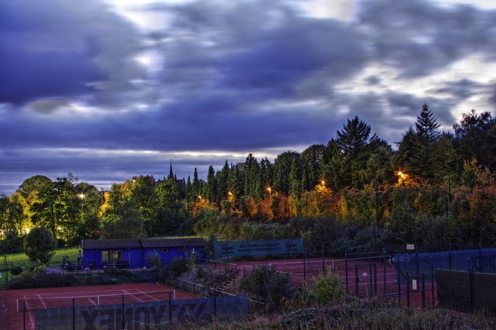 Tennis courts and trees at dusk in Aachen, Germany