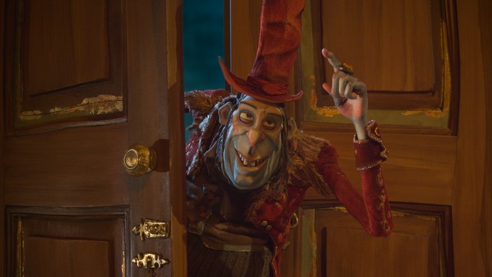 The Boxtrolls character in a hat by a door