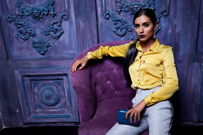 Woman in yellow shirt sitting on armchair