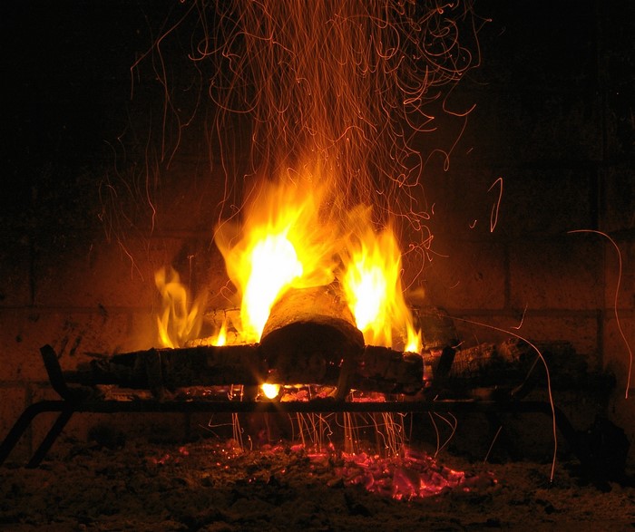 Fireplace with burning logs and sparks