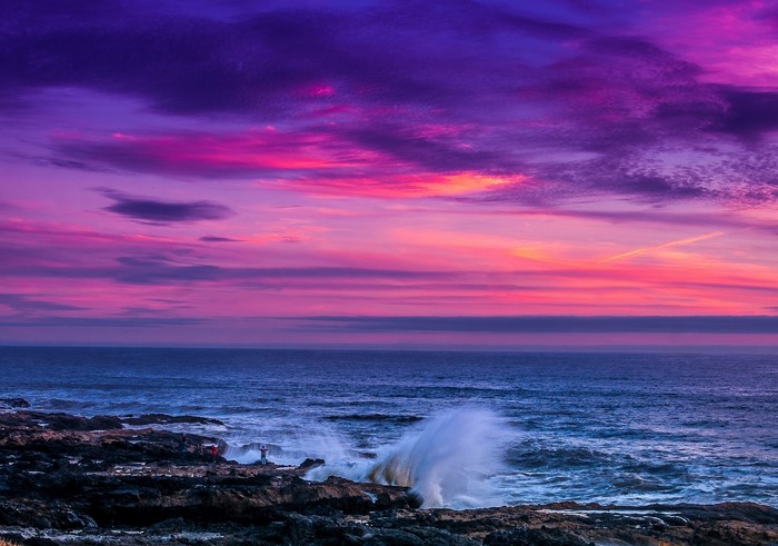 Sunset over the ocean with crashing waves