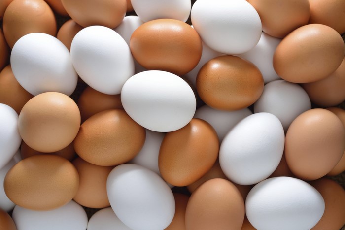 A pile of brown and white eggs