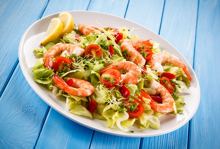Shrimp salad with tomatoes and lettuce on a plate