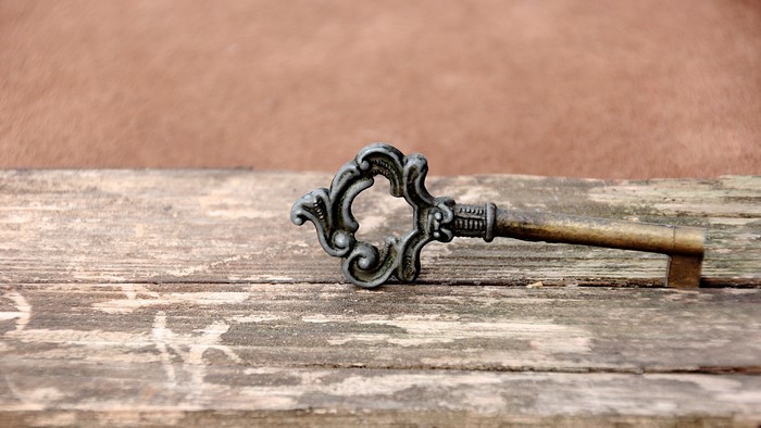 Antique key on wooden planks
