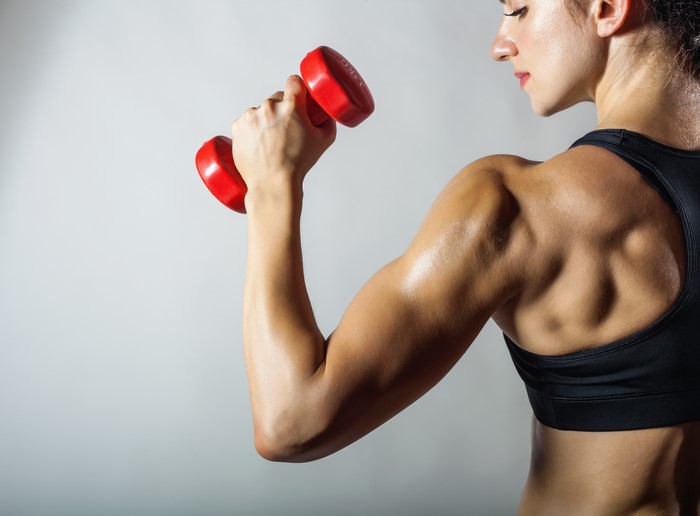 Woman lifting red dumbbell