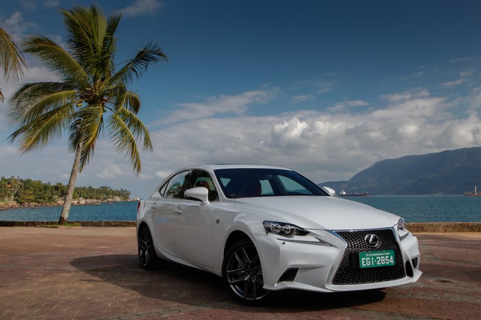 White Lexus IS F-Sport by the ocean with palm trees