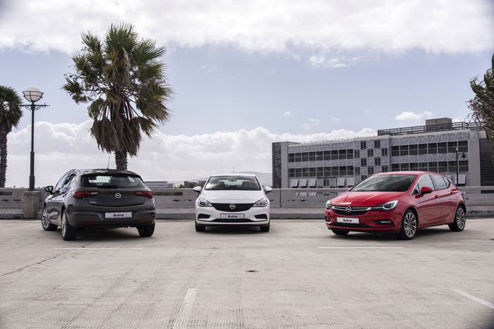 Three Opel Astra cars parked in a lot