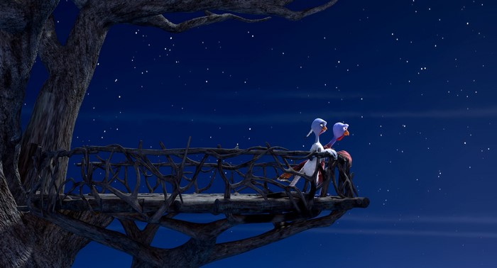 Two turkeys on a wooden platform at night