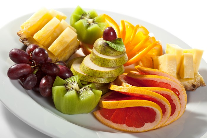 Fruit platter with grapes, kiwi, pears, oranges, grapefruit, and pineapple