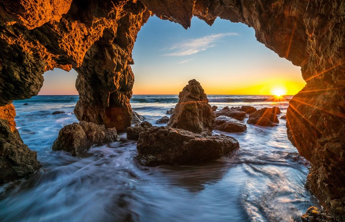 Sunset through a cave opening at Malibu, USA