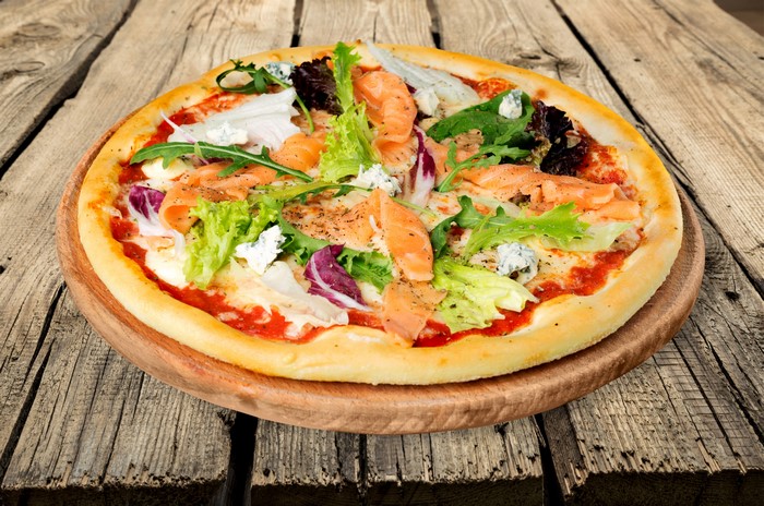 Pizza with salmon and salad