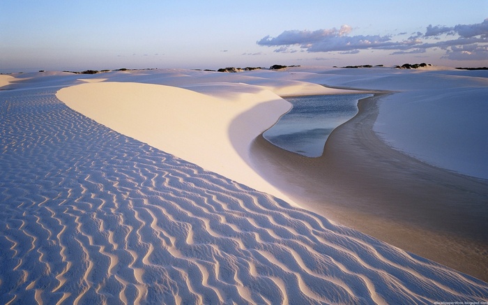Desert dunes with a small body of water