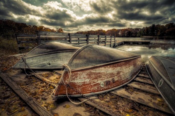 Boats on a Dock with Autumn Trees and Cloudy Sky