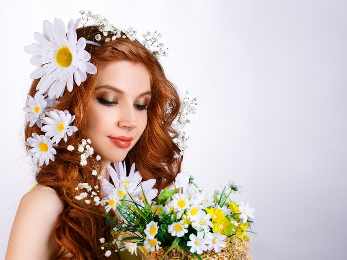 Woman with red hair and daisies
