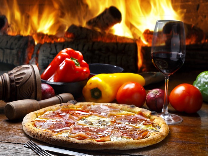 Pizza with Bell Peppers, Tomatoes, and Red Wine by Fireplace
