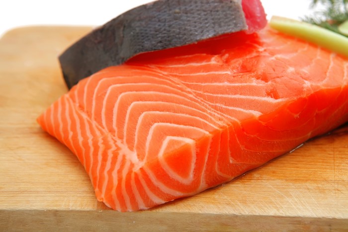 Salmon fillet and tuna steak on a cutting board