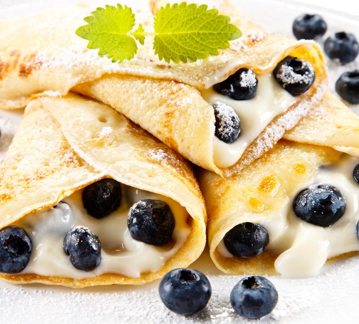 Blueberry crepes with powdered sugar and mint