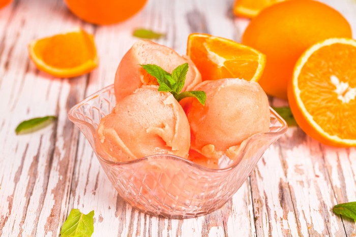 Orange ice cream with mint and oranges