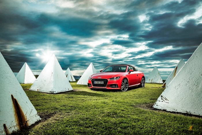 Red Audi TT Roadster among white pyramids