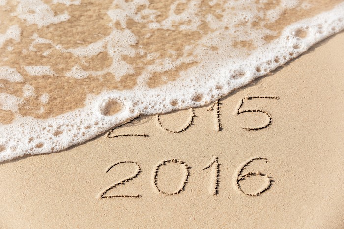 2015 and 2016 written in sand with waves