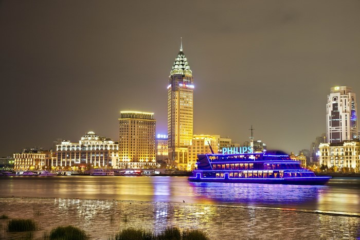 Shanghai skyline with Philips riverboat at night