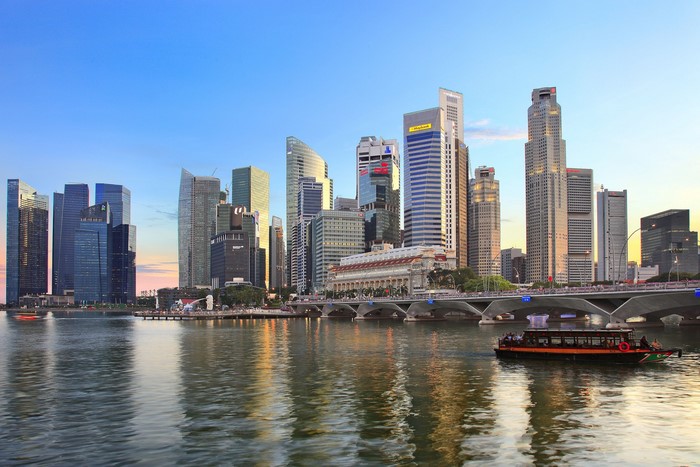 Singapore skyline with skyscrapers and a boat on the water