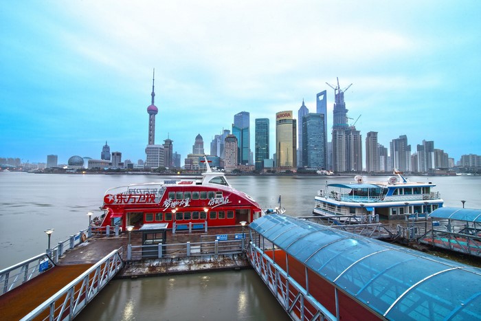 Shanghai skyline with boats on the Huangpu River