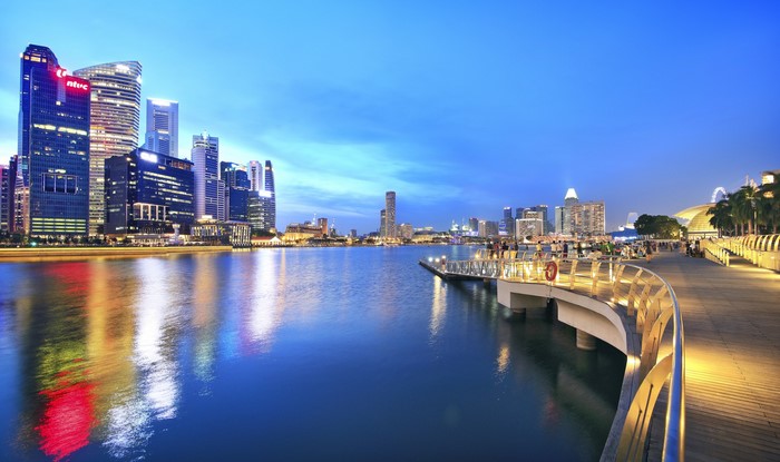 Singapore skyline at dusk with waterfront promenade