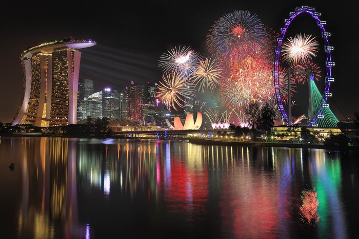 Singapore Skyline with Fireworks and Ferris Wheel at Night