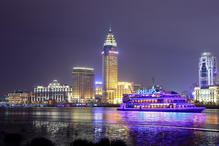 Shanghai skyline with Philips riverboat at night