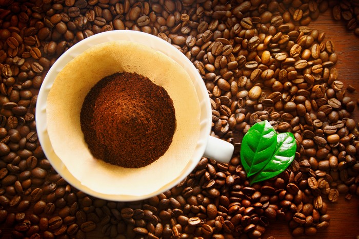Coffee beans and ground coffee in a filter