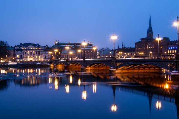 Stockholm at night with bridge and river reflections