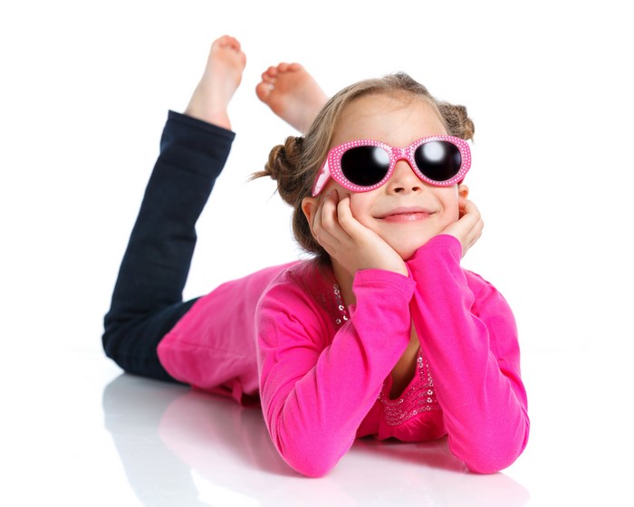 Little girl with pink sunglasses smiling