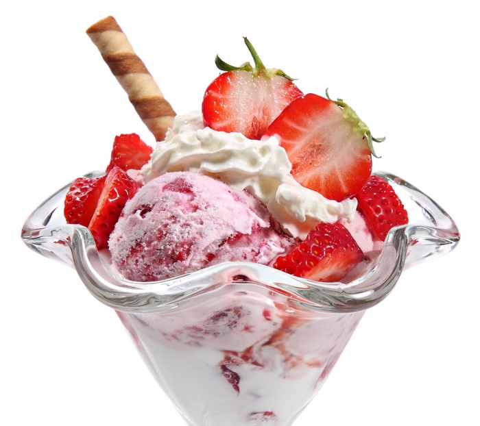 Strawberry ice cream sundae with whipped cream and wafer