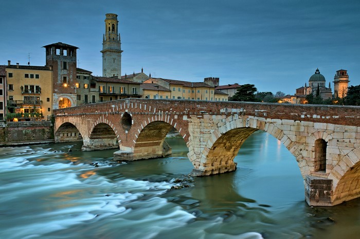 Ponte Pietra bridge over the Adige River in Verona, Italy at dusk