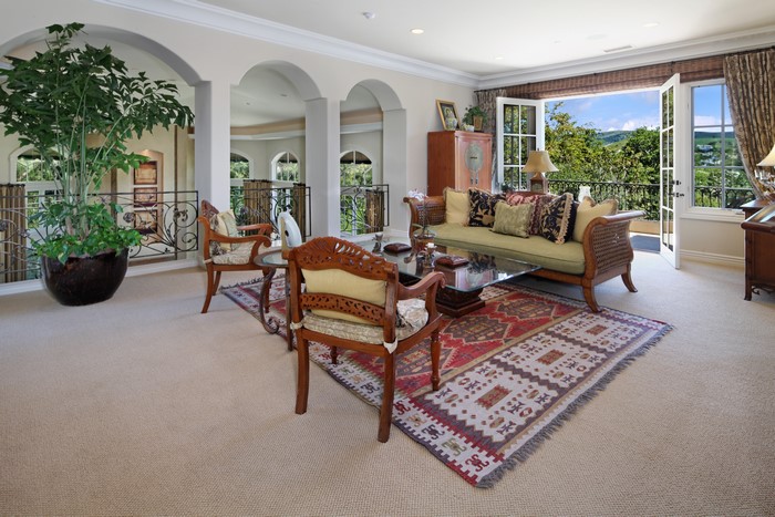 Living room with sofa, carpet, and chairs
