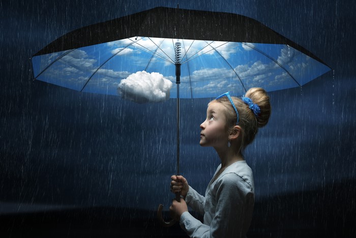 Girl with umbrella showing sky and clouds in rain