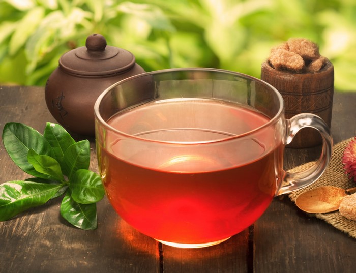 Tea in a mug with sugar cubes and leaves