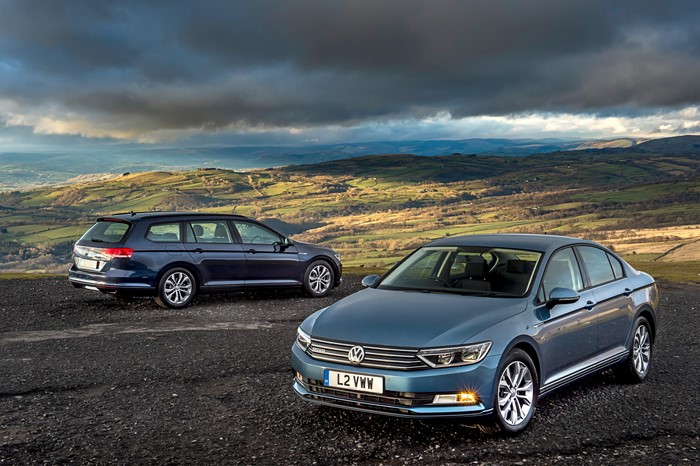 Two Volkswagen Passat cars on a hill