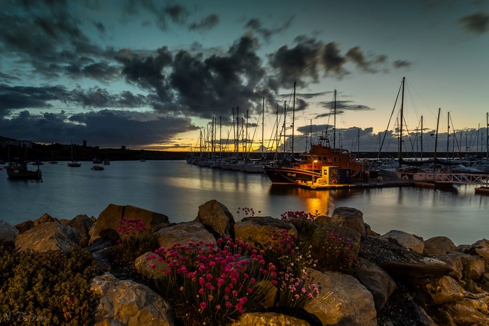 Lifeboat and yachts in Holyhead harbor at dusk