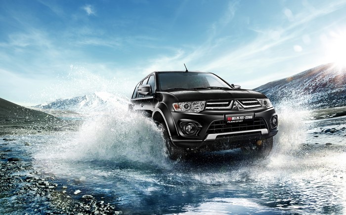 Black Mitsubishi Pajero Sport driving through water