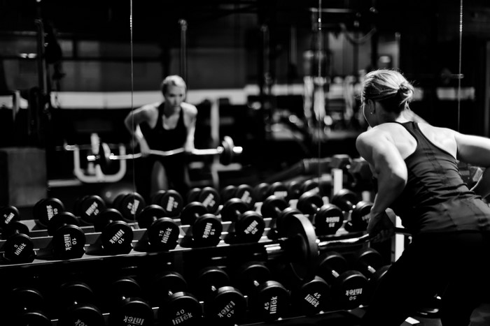 Woman lifting dumbbells in gym