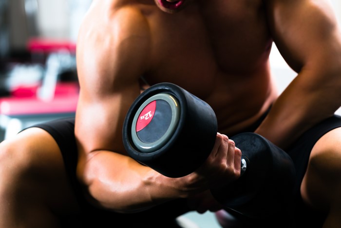 Man lifting dumbbell in gym