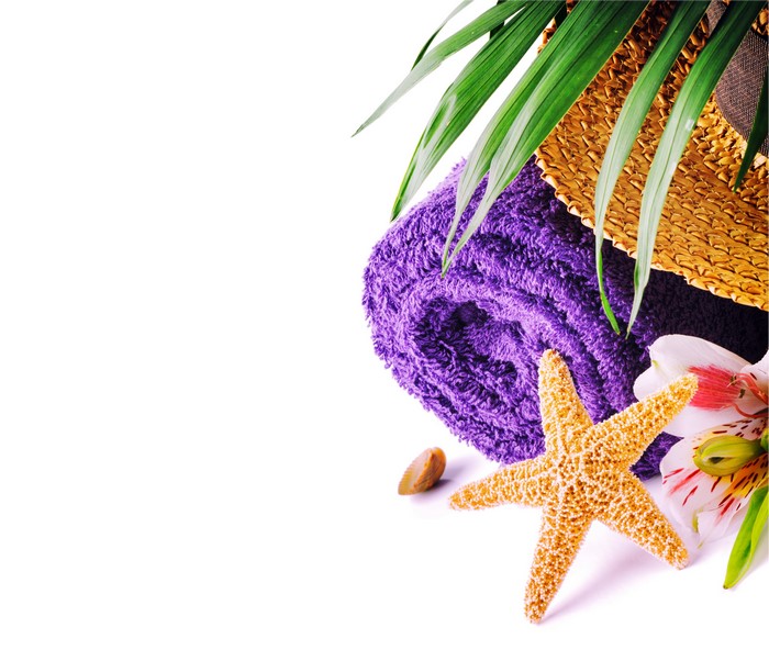 Rolled purple towel with starfish and flowers