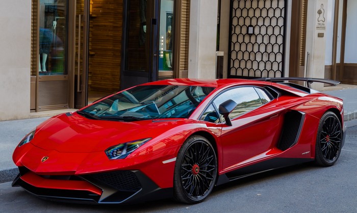Red Lamborghini Aventador LP700-4 parked on street